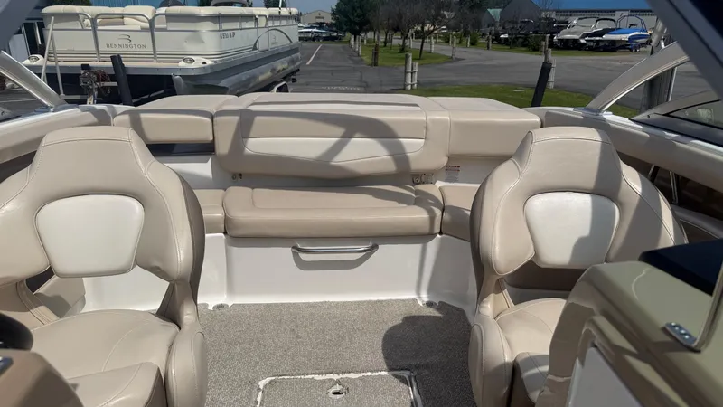Slide: The Image of 2011 Chaparral 206 SSi boat interior with beige seating and carpeted floor. - 18