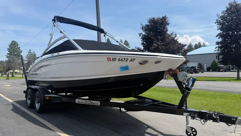 Slide: The Image of 2011 Chaparral 206 SSi boat on trailer, parked outdoors on a sunny day. - 3