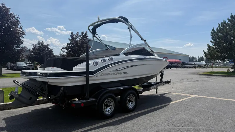 Slide: The Image of 2011 Chaparral 206 SSi boat on trailer in parking lot, sunny day. - 4