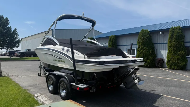 Slide: The Image of 2011 Chaparral 206 SSi boat on trailer, parked near industrial building. - 6