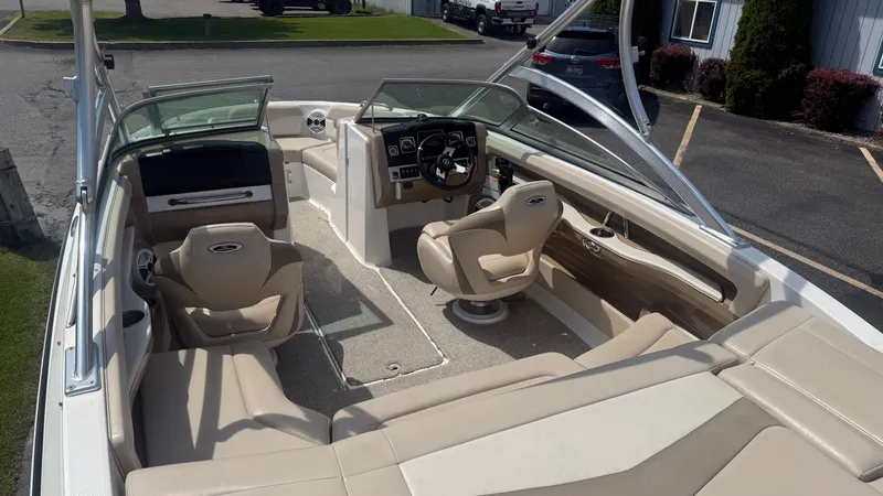 Slide: The Image of 2011 Chaparral 206 SSi boat interior with beige seating and modern dashboard. - 7