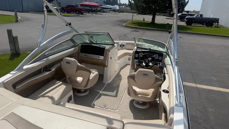Slide: The Image of 2011 Chaparral 206 SSi boat interior with beige seating and modern dashboard. - 8