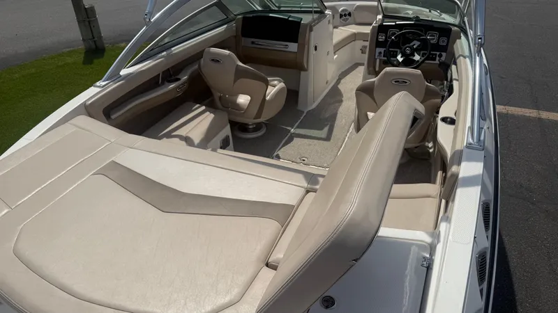 Slide: The Image of 2011 Chaparral 206 SSi boat interior with beige seating and steering console. - 9