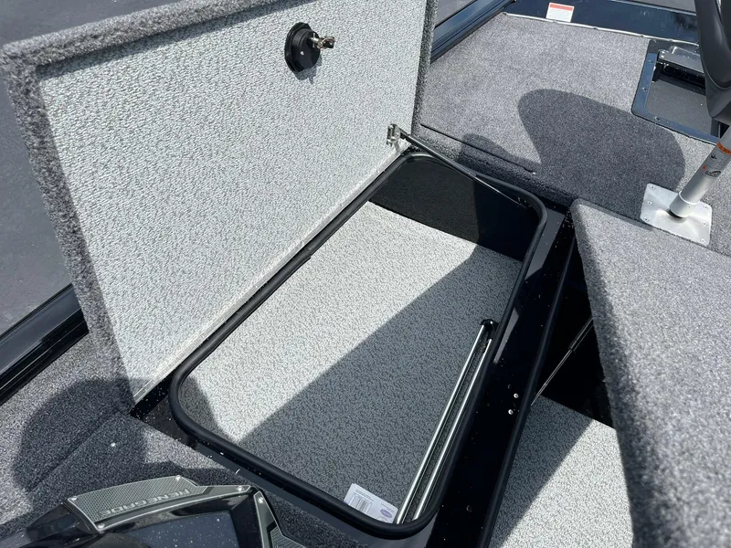 Slide: The Image of 2026 Lund 1875 Renegade SS boat storage compartment with open lid, showcasing interior space. - 13