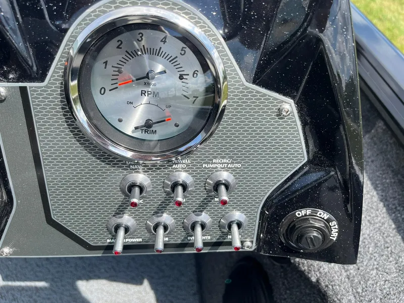 Slide: The Image of Dashboard of 2026 Lund 1875 Renegade SS boat with RPM gauge and control switches. - 17