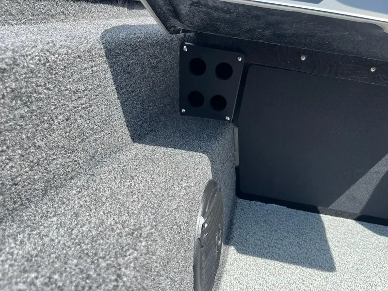 Slide: The Image of Interior of 2026 Lund 1875 Renegade SS boat, featuring carpeted flooring and speaker. - 20