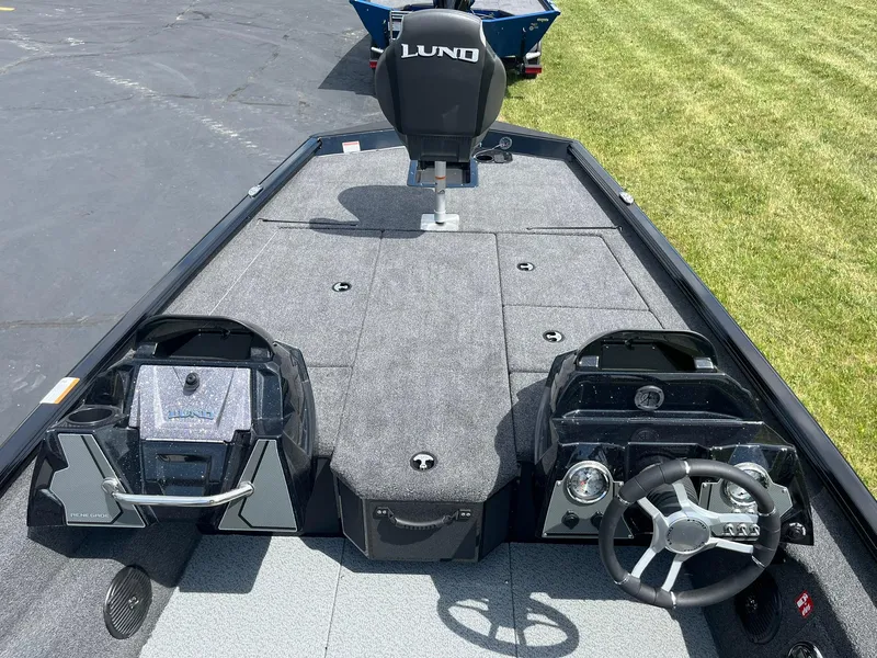 Slide: The Image of 2026 Lund 1875 Renegade SS boat interior with steering wheel and control panel. - 6