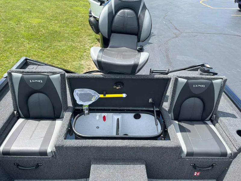 Slide: The Image of 2026 Lund 1875 Renegade SS boat interior with seating and storage compartments. - 8