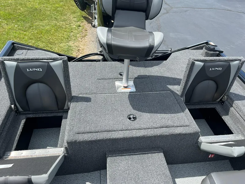 Slide: The Image of 2026 Lund 1875 Renegade SS boat interior with gray seating and storage compartments. - 9