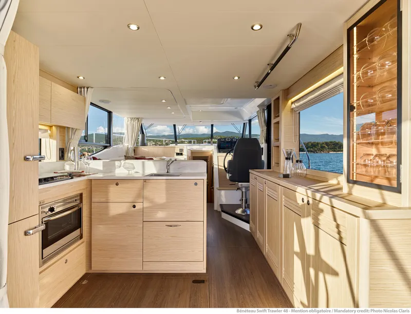 Slide: The Image of Luxurious interior of 2026 Beneteau Swift Trawler 48 with modern kitchen and panoramic views. - 13