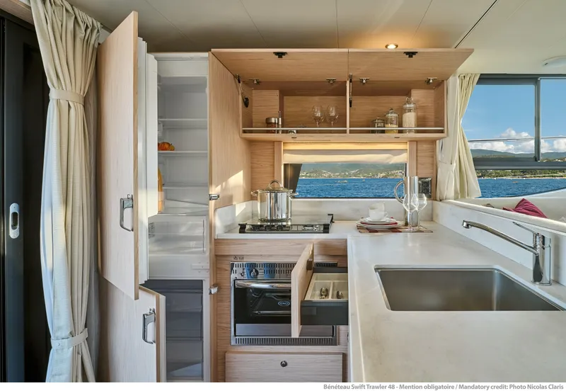 Slide: The Image of Modern kitchen interior of 2026 Beneteau Swift Trawler 48 with ocean view. - 16