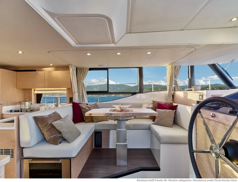 Slide: The Image of Luxurious interior of 2026 Beneteau Swift Trawler 48 with elegant seating and scenic views. - 21