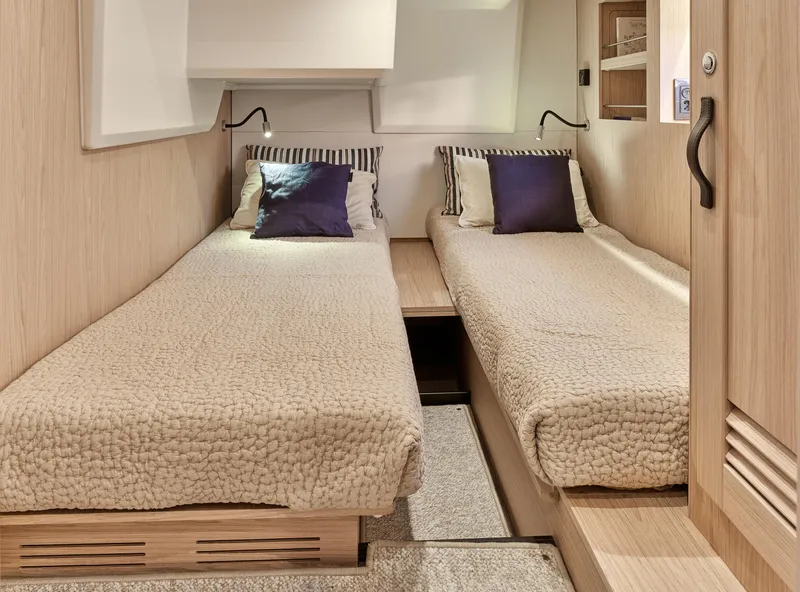 Slide: The Image of 2026 Beneteau Swift Trawler 48 cabin with twin beds and modern decor. - 26