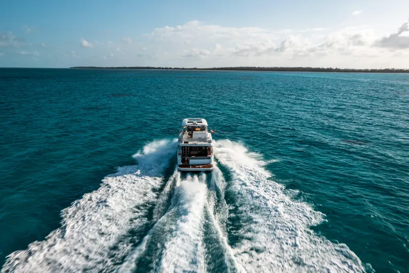 Slide: The Image of 2026 Beneteau Swift Trawler 48 cruising on open ocean, leaving a wake behind. - 3