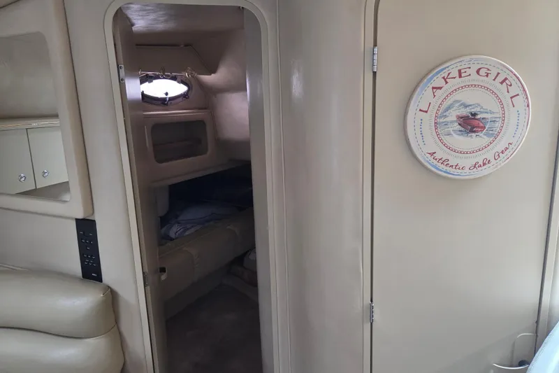Slide: The Image of Interior of 1998 Sea Ray 310 Sundancer with cozy cabin and "Lake Girl" decor. - 16