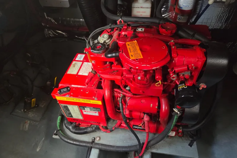 Slide: The Image of Engine compartment of a 1998 Sea Ray 310 Sundancer with a red marine engine. - 18