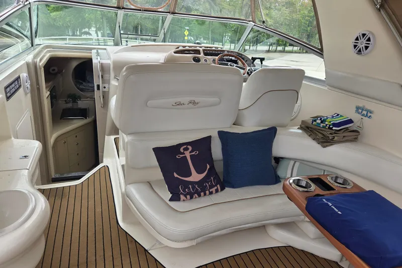 Slide: The Image of Interior of a 1998 Sea Ray 310 Sundancer boat with plush seating and nautical decor. - 8