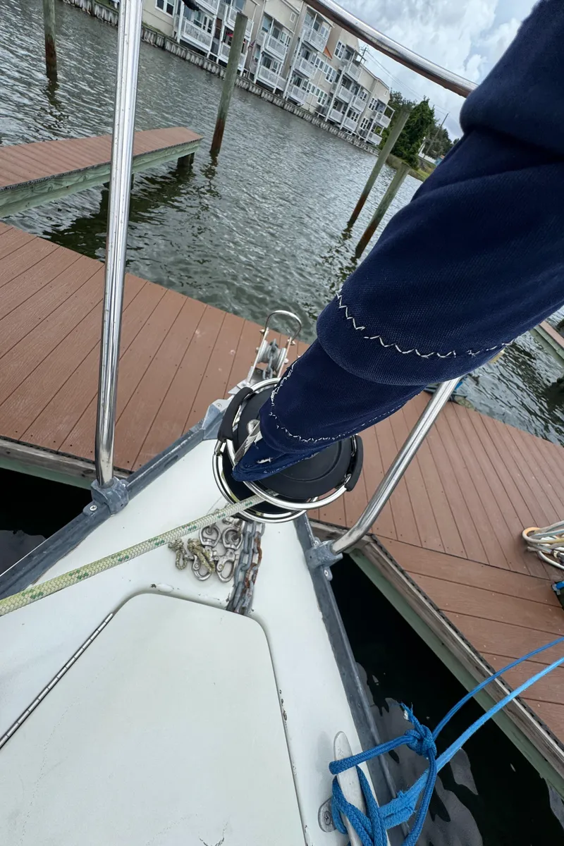 Slide: The Image of Bow of 1986 C&C 29 sailboat docked, showing deck fittings and mooring lines. - 17