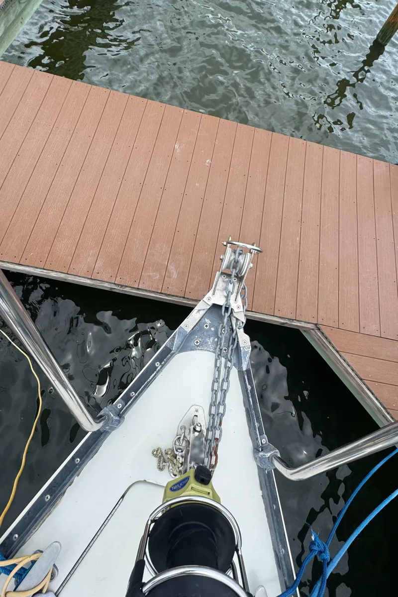 Slide: The Image of Bow of 1986 C&C 29 sailboat docked, showing anchor and chain. - 20