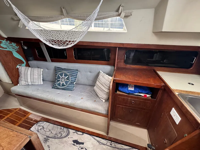 Slide: The Image of Interior of a 1986 C&C 29 sailboat with cozy seating and nautical decor. - 24
