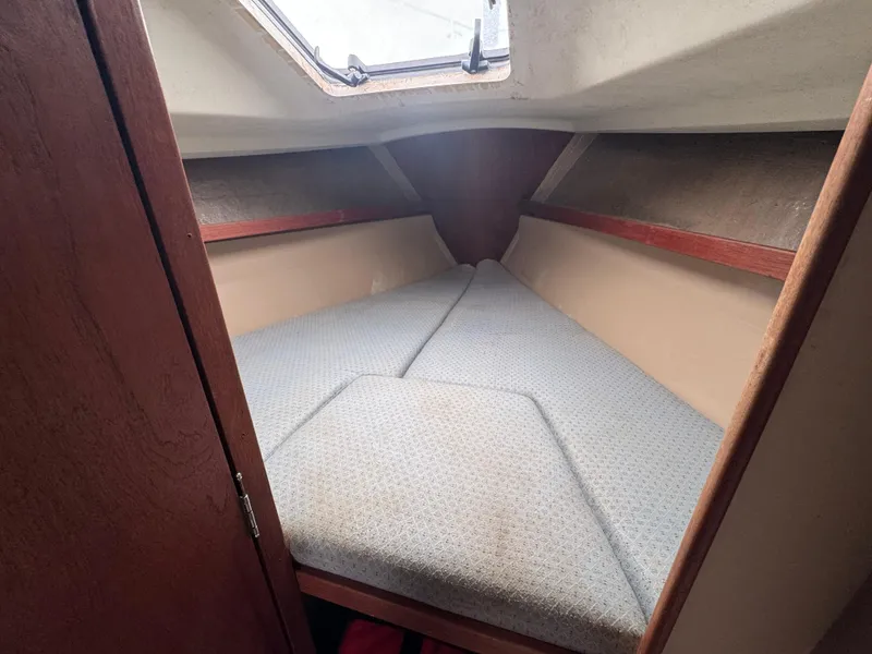 Slide: The Image of 1986 C&C 29 sailboat cabin with V-berth and wooden interior. - 26