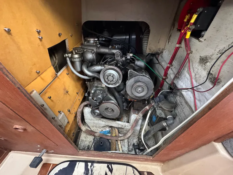 Slide: The Image of Engine compartment of a 1986 C&C 29 sailboat, showing mechanical components and wiring. - 29