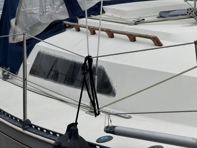 Slide: The Image of 1986 C&C 29 sailboat deck with blue canopy and rigging details. - 3