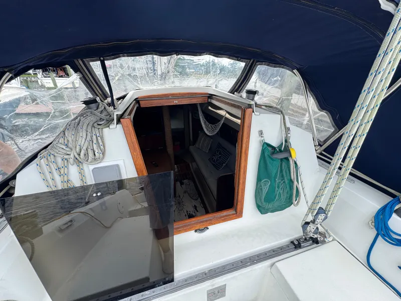 Slide: The Image of 1986 C&C 29 sailboat cockpit with ropes, canopy, and cabin entrance. - 9