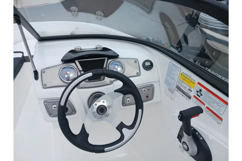 Slide: The Image of 2025 Tahoe 200 S boat dashboard with steering wheel and control panel. - 6