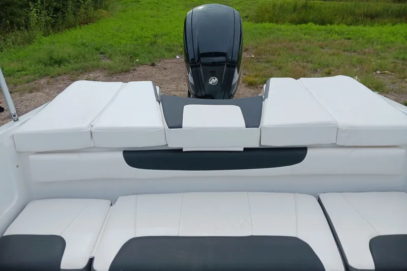 Slide: The Image of 2025 Tahoe 200 S boat with white cushioned seating and outboard motor. - 9
