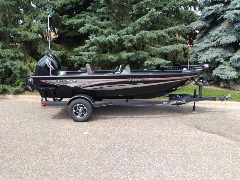 Slide: The Image of 2025 Ranger VS1665SC boat on trailer, parked near lush green trees. - 4