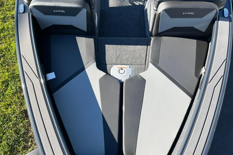 Slide: The Image of 2026 Lund 1875 Crossover XS boat interior with seating and storage compartments. - 11