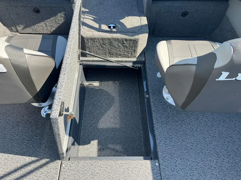 Slide: The Image of 2026 Lund 1875 Crossover XS boat interior with open storage compartment and seating. - 20