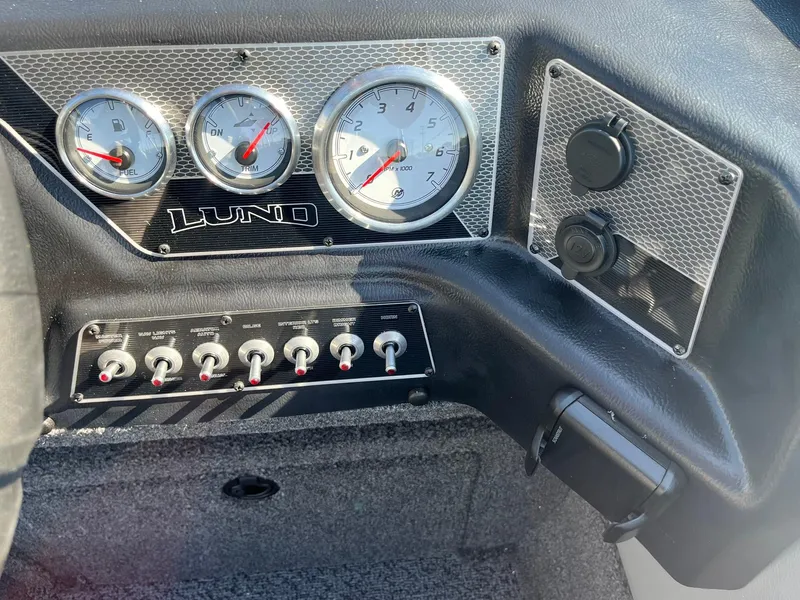 Slide: The Image of Dashboard of 2026 Lund 1875 Crossover XS boat with gauges and switches. - 22