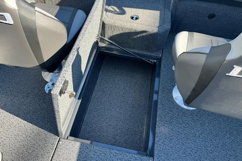 Slide: The Image of 2026 Lund 1875 Crossover XS boat interior with open storage compartment and seating. - 28