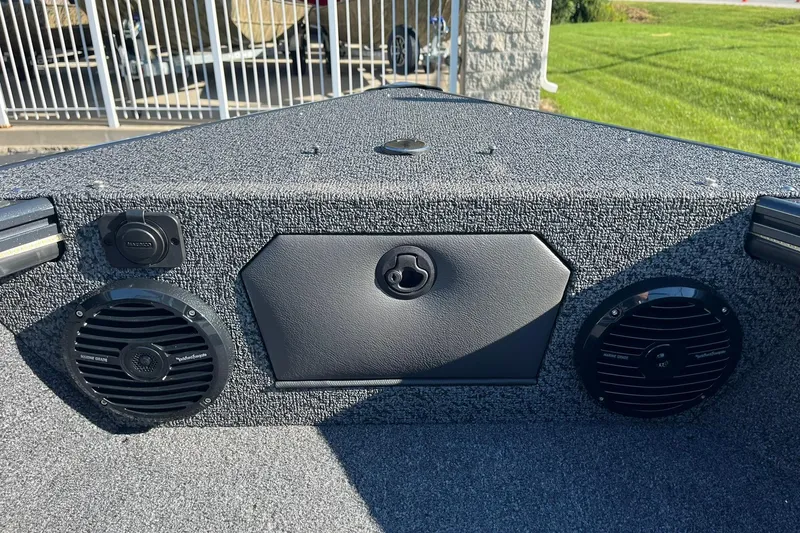 Slide: The Image of 2026 Lund 1875 Crossover XS boat interior with speakers and textured surface. - 32