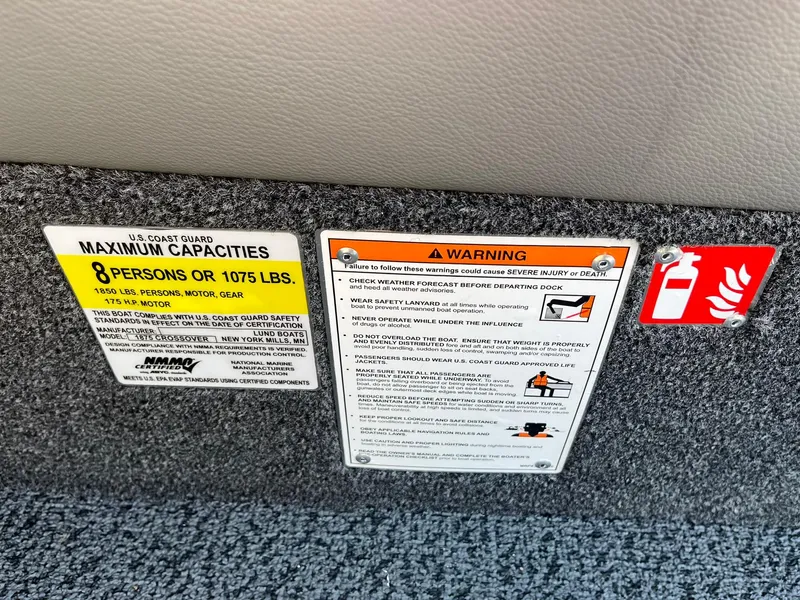 Slide: The Image of 2026 Lund 1875 Crossover XS safety labels showing maximum capacity and warning instructions. - 35
