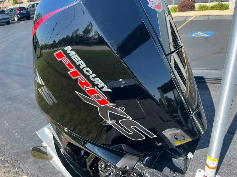 Slide: The Image of 2026 Lund 1875 Crossover XS with Mercury Pro XS engine, parked outdoors. - 37