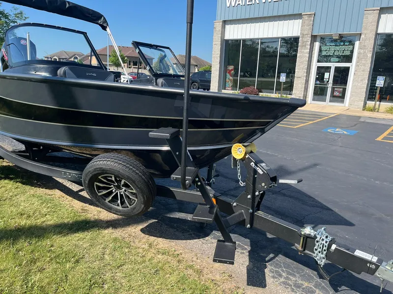 Slide: The Image of 2026 Lund 1875 Crossover XS boat on trailer outside dealership. - 39