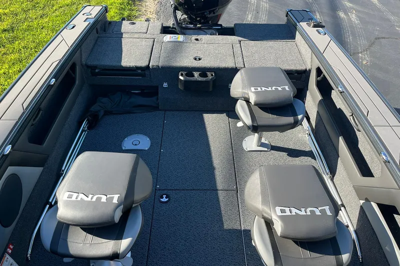 Slide: The Image of 2026 Lund 1875 Crossover XS boat interior with seating and storage compartments. - 9