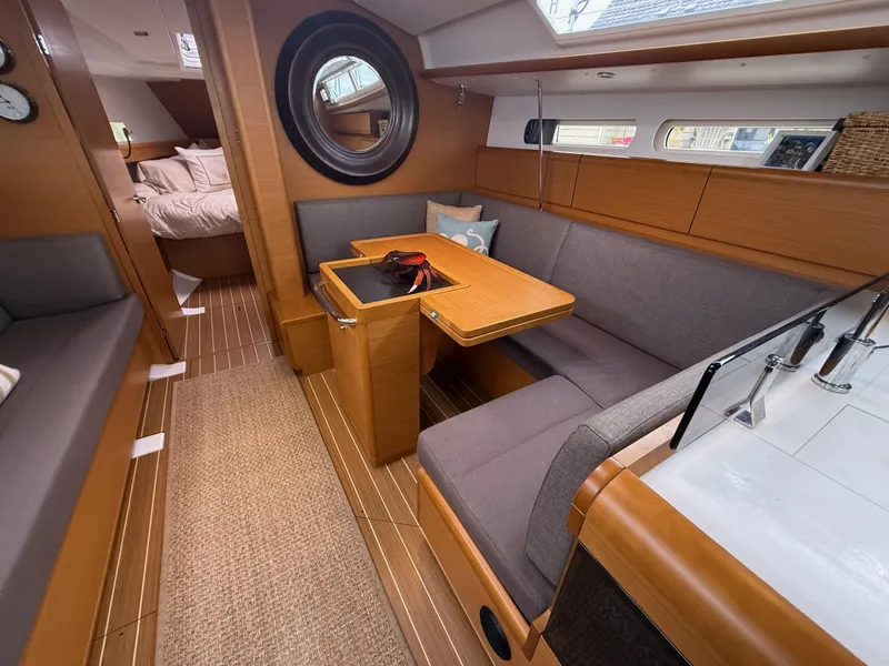Slide: The Image of Interior of 2011 Jeanneau 409 sailboat with cozy seating and wooden finishes. - 10