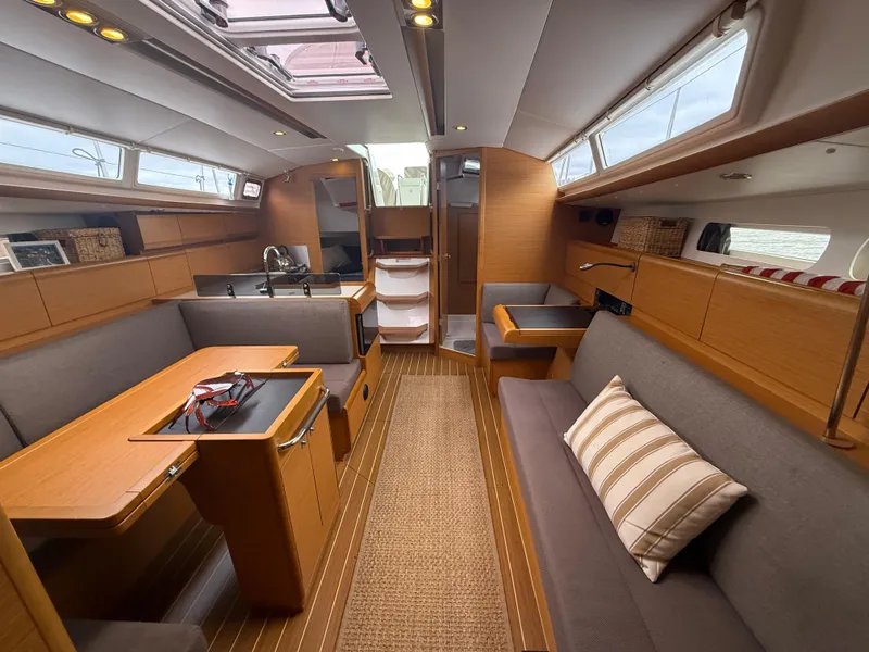 Slide: The Image of Interior of 2011 Jeanneau 409 sailboat with modern wood finish and comfortable seating. - 11