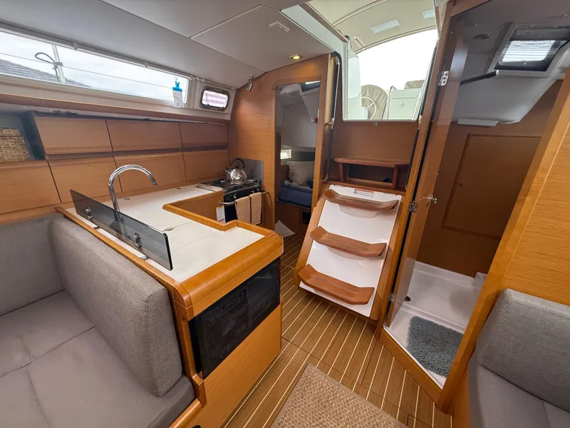 Slide: The Image of Interior of 2011 Jeanneau 409 sailboat with modern kitchen and cozy seating area. - 13
