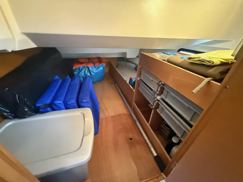 Slide: The Image of Storage area inside a 2011 Jeanneau 409 sailboat, featuring organized compartments and equipment. - 20