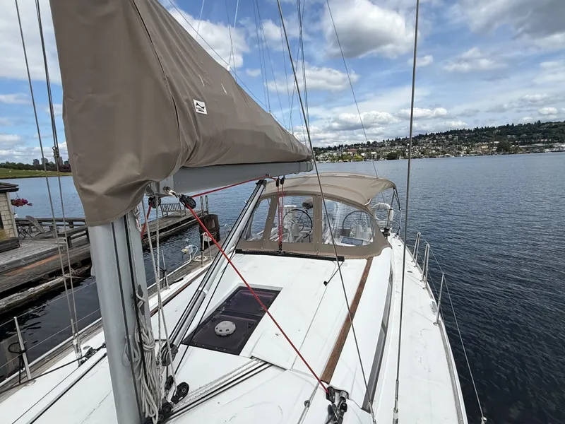 Slide: The Image of 2011 Jeanneau 409 sailboat docked on calm water under a partly cloudy sky. - 30