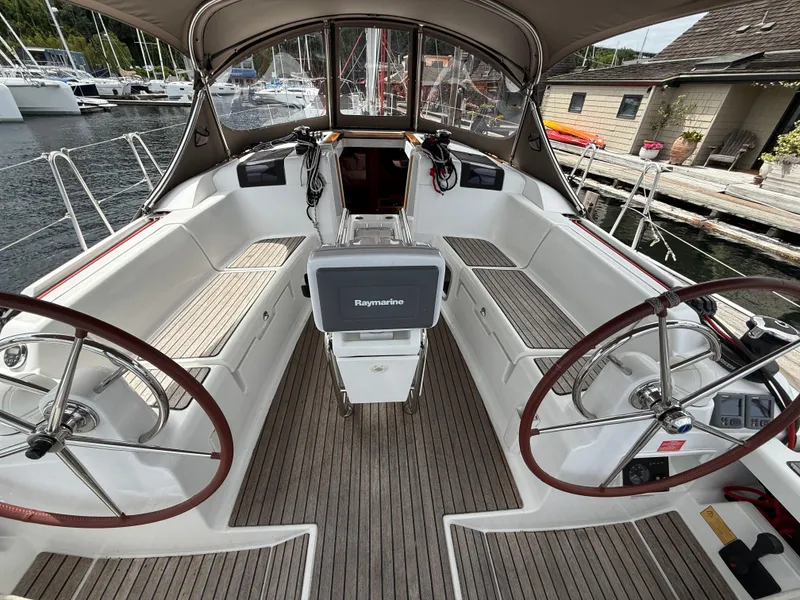Slide: The Image of Cockpit of 2011 Jeanneau 409 sailboat with dual steering wheels and Raymarine navigation system. - 5