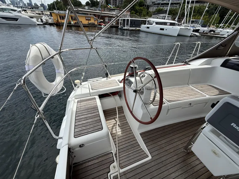 Slide: The Image of Cockpit of 2011 Jeanneau 409 sailboat with wooden deck and steering wheel. - 6