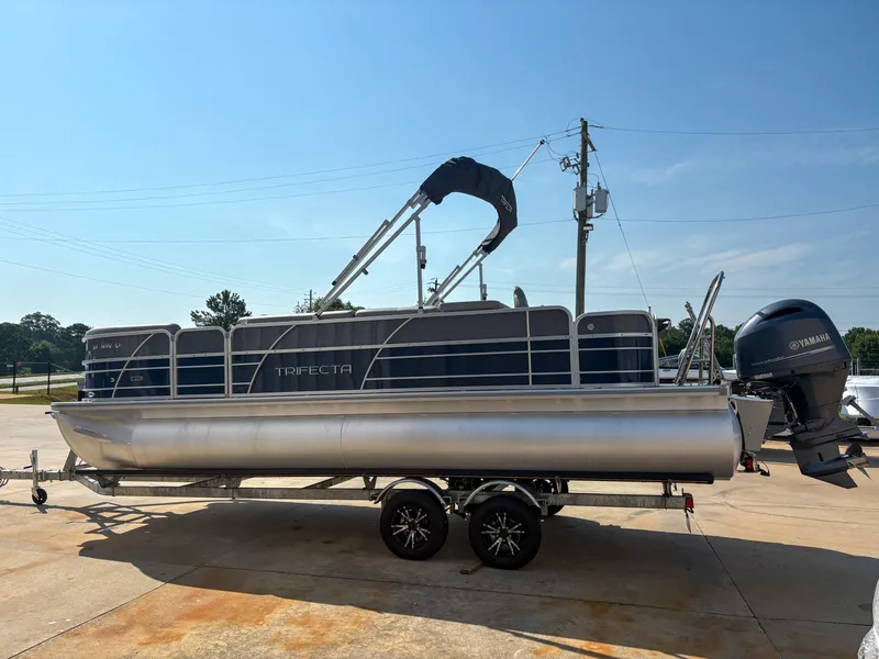 Slide: The Image of 2022 Trifecta CS 24RFC pontoon boat on trailer, featuring Yamaha outboard motor. - 1