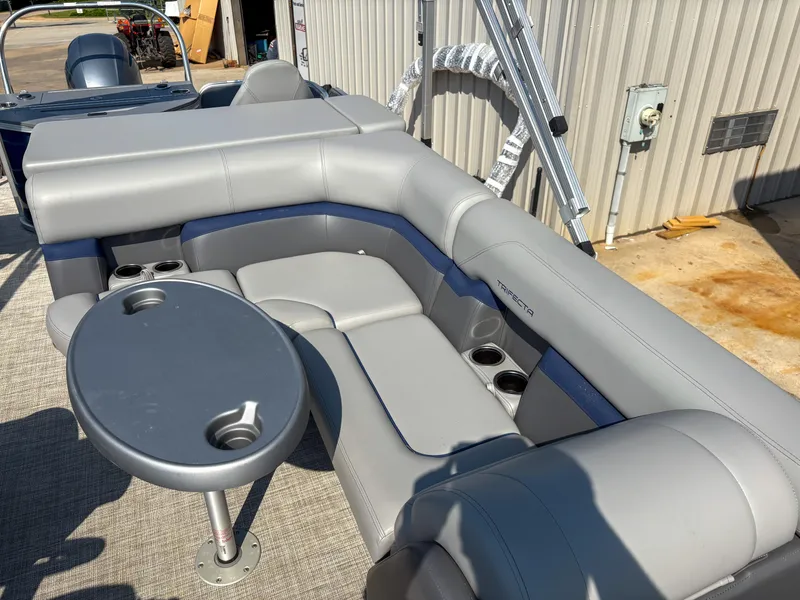 Slide: The Image of 2022 Trifecta CS 24RFC boat interior with gray seating and cup holders. - 12