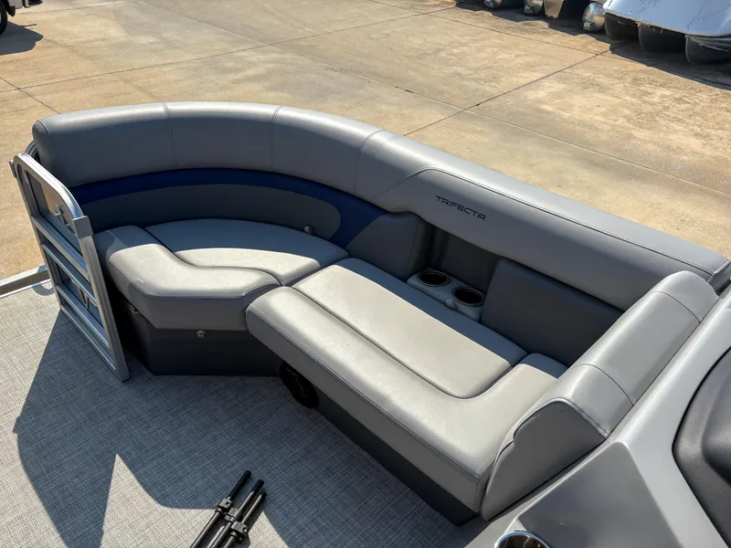 Slide: The Image of 2022 Trifecta CS 24RFC pontoon boat with gray seating and cup holders. - 15